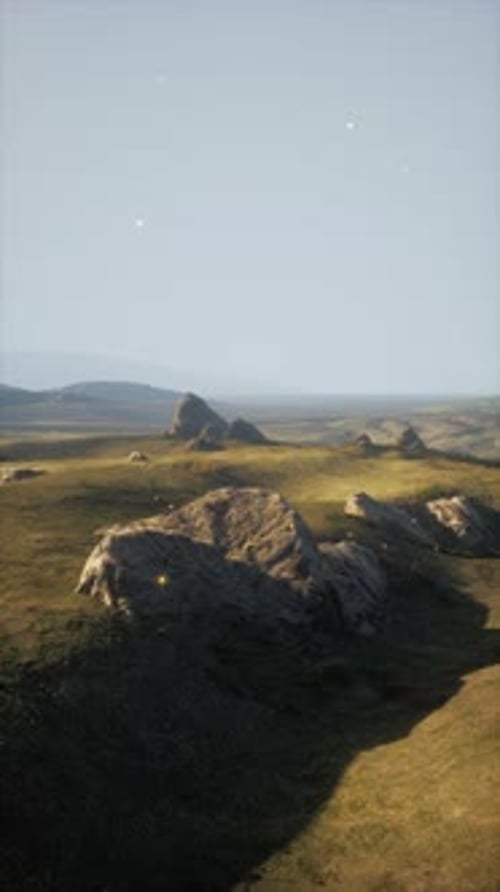 Rockstrewn Field With Distant Grass