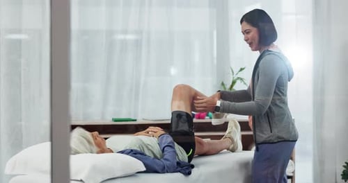 Woman Receiving Leg Stretching From Physical Therapist