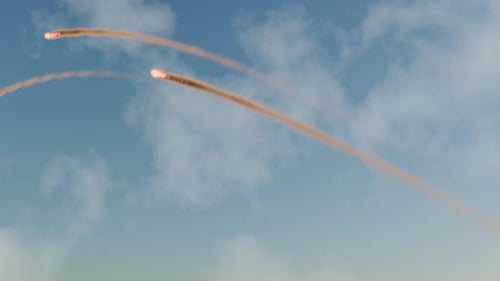 Multiple Rockets Launching and Flying Through Blue Sky