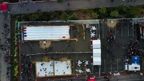 Overhead View Of People Enjoying Ice Activities With Slides On The Park. - aerial shot