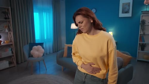 Adult Woman Suffering from Stomach Ache at Home