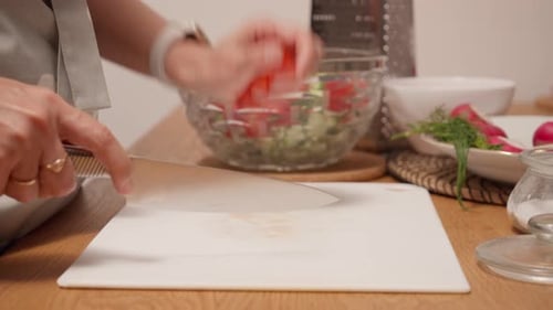 Adult Slicing Tomato for Salad Preparation at Home