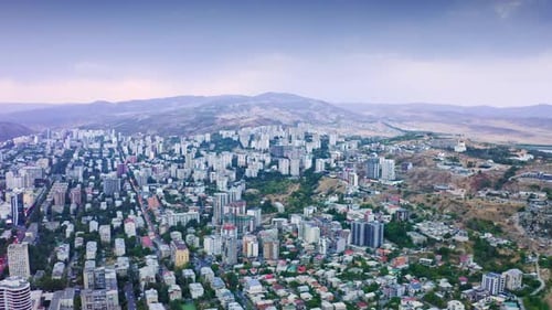 Wide Aerial View of City Surrounded by Mountains