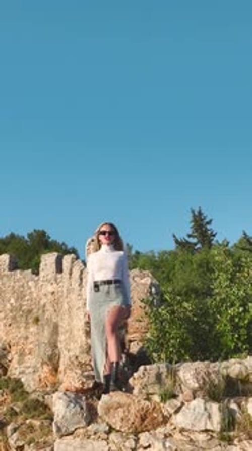Vertical Video Beautiful Model Posing on a Cliff With a Panoramic View of the Mediterranean Sea