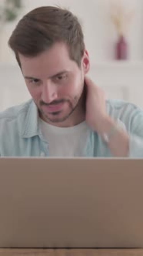 Man Working Thoughtfully On Laptop at Home