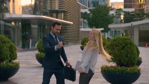 Two Business Person Coworkers Dancing Outside Office Building After Successful Working Day, Celebrat