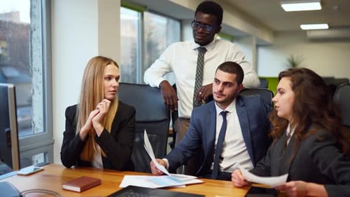 International Business Partners Discuss Project on Meeting in Office Business Woman Shows Data