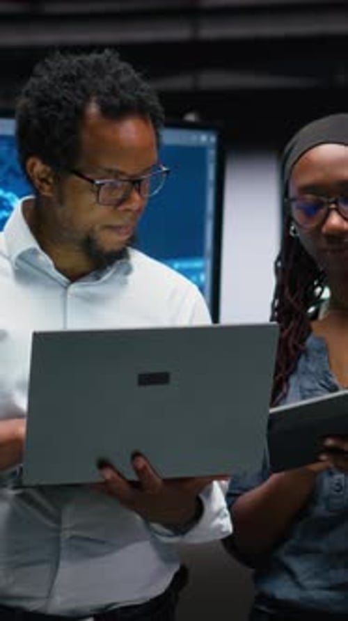 Vertical Video Tech Agency Colleagues Collaborating to Optimize AI Performance in Office