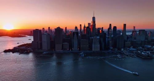 Architecture of Manhattan in the orange rays of setting sun.