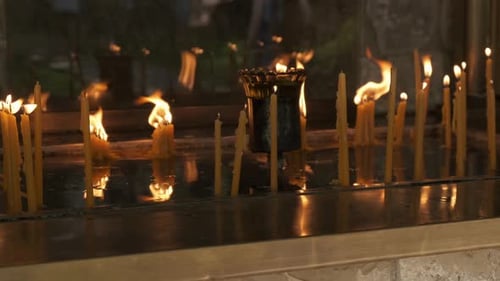 Burning Candles in Dim Religious Worship Setting