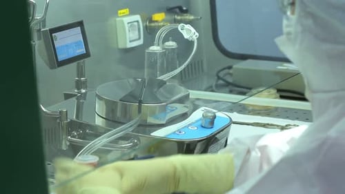 Female scientist performs pharmaceutical laboratory experiment with modern equipment