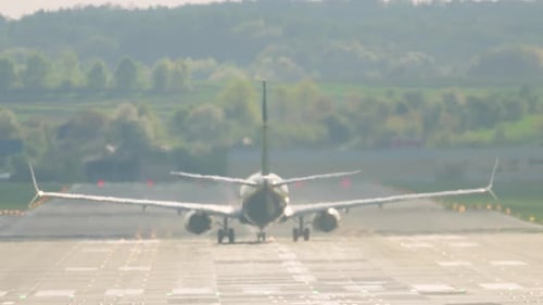 Passenger aircraft launches into the sky from the runway at a scenic airport