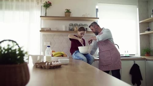 Father and Son Baking Together in Modern Kitchen