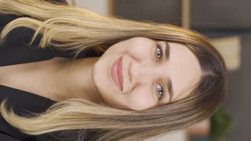 Vertical video of Portrait of smiling woman.