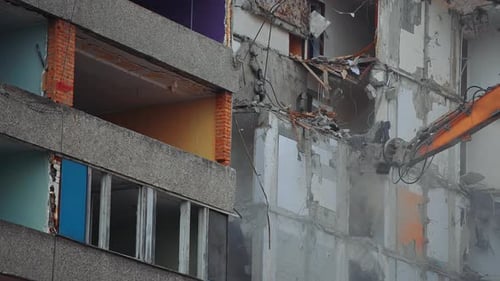 Demolition building by machine. Destruction excavator house demolishing.