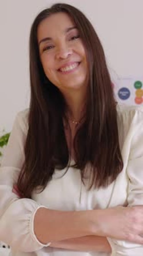 Portrait of Mid Adult Businesswoman Looking at Camera Standing in the Office