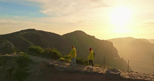 Flying Around Pair of Hikers on the Top of Mountain Aerial Drone Shot of Man and Woman Travel with