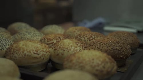 Close up shot of homemade burger bread covered with seeds in cups