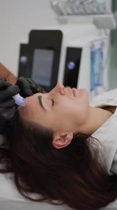 Woman Receiving Facial Treatment in Medical Clinic