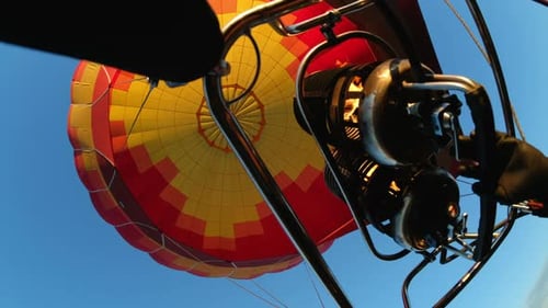 Hot air balloon down to top view with burners firing