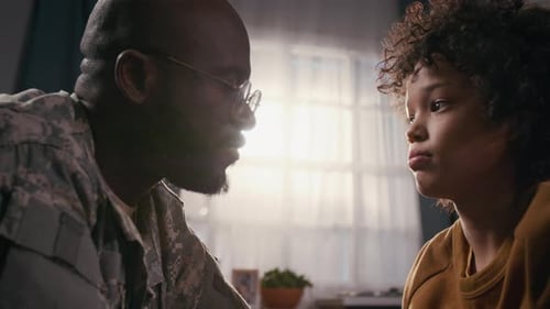 Touching Moment Between Soldier and Child Indoors
