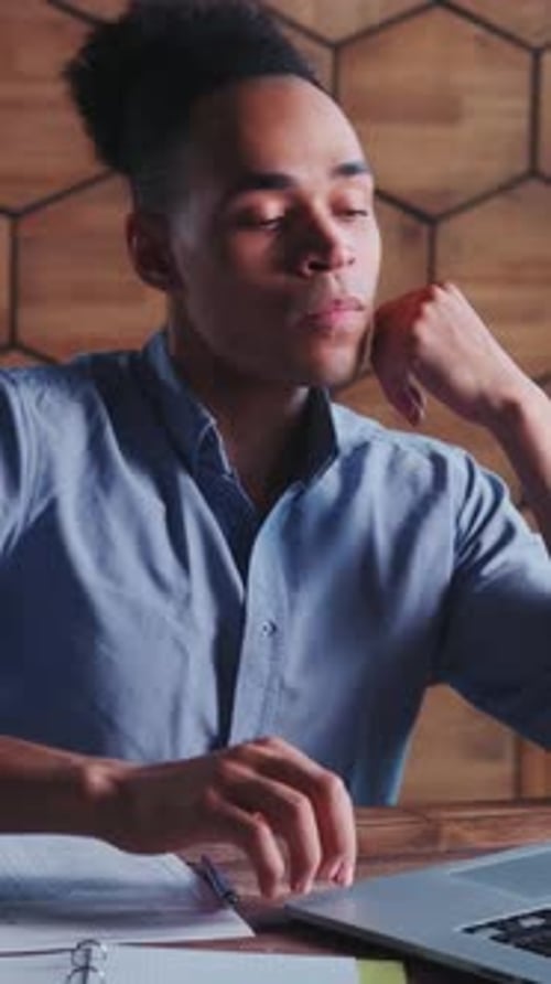 Young Focused African American Business Man Uses Laptop Sits at Desk in Office