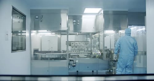 Scientists in Sterile Protective Clothing Work on a Modern Laboratory
