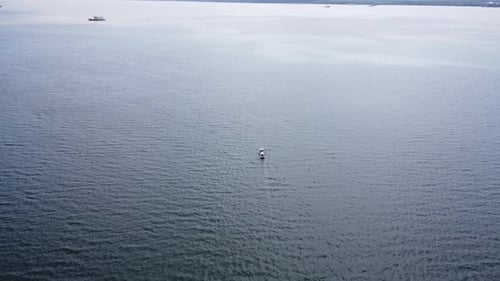 Aerial view of fishing boats sailing out to sea in search of fish