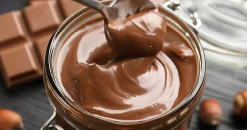Delicious Hazelnut Chocolate Spread Pulled from Jar with Spoon