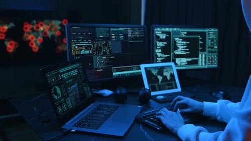 Close up view. Young professional female hacker is indoors by computer