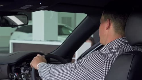 Young Man Gives Thumbs Up in Car