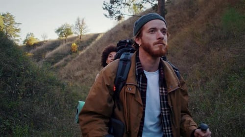 Couple Hiking on a Mountain Path with Backpacks
