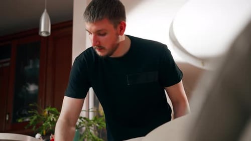 Close Up Professional Cleaning in an Apartment the Cleaner Cleans a Textile Sofa with a Brush and