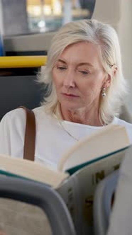 Woman Reads Book on Public Transport