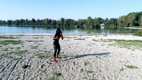 Woman Doing Calisthenics at Beach on Lake