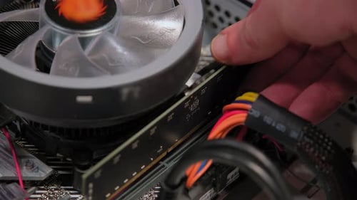 Hands Assemble Memory Parts to Mother Board in PC Close Up