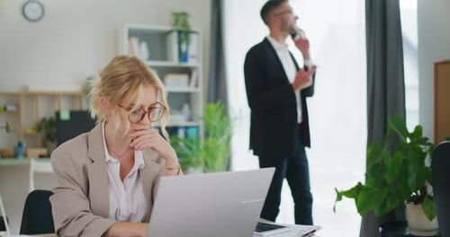 Concentrated Office Worker on Laptop