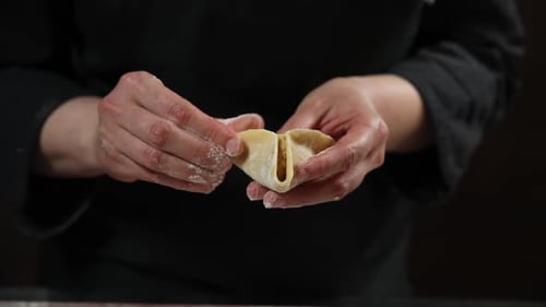 Step by step the chef prepares ravioli. The chef works with the dough