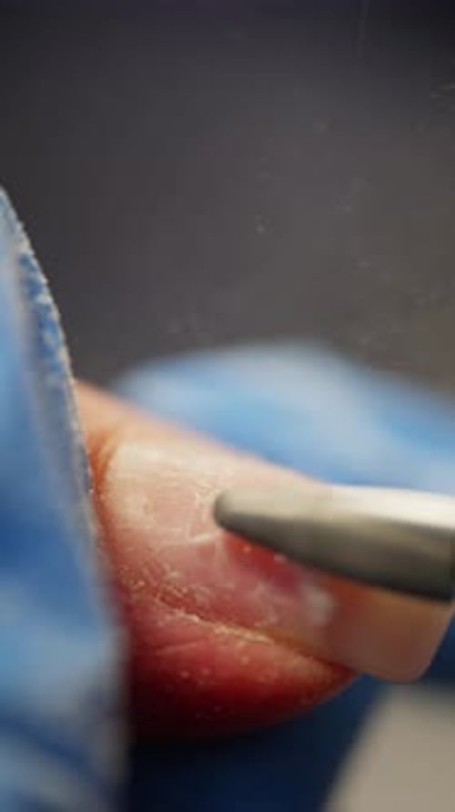 Closeup of Removing Old Material During a Manicure