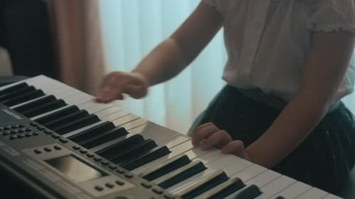 Young Child Plays Electronic Piano at Home