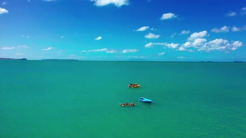 Group Of Trainees On Boat In The Sea During Life Rescue Training At Daytime. - aerial
