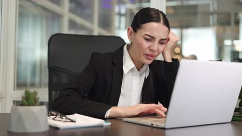 Annoyed Female Freelancer Working on Laptop and Having Problem at Office Work