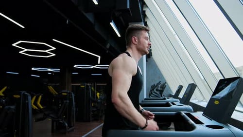 Sportsman is running on a treadmill.