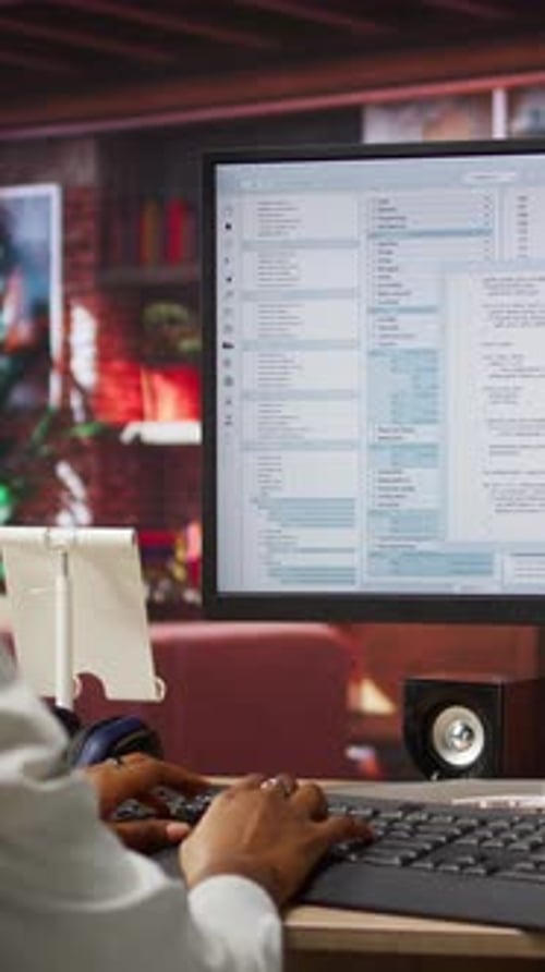 Adult Working with Computer Code at Desk