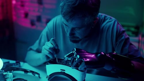 Man Repairing VR Headset with Robotic Arm