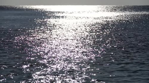 Abstract Shining Sun Reflections on Blue Surface of Sea Waves Bokeh Sun Glare Reflected in Water
