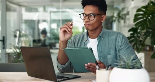 Man, tablet and designer in agency for thinking, project management and brainstorming at laptop