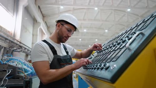 Worker On Factory Analyzes The Production Process And Programming Industrial CNC Machine Tool