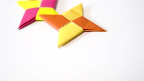 Colorful Origami Ninja Stars on a White Background