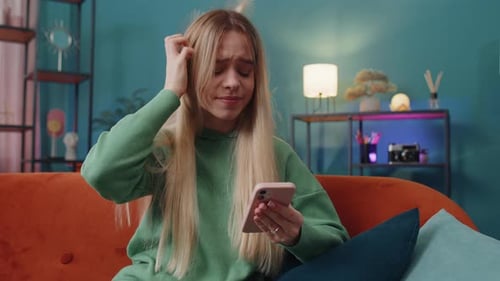 Distressed Woman Reacting to Content on Mobile Phone